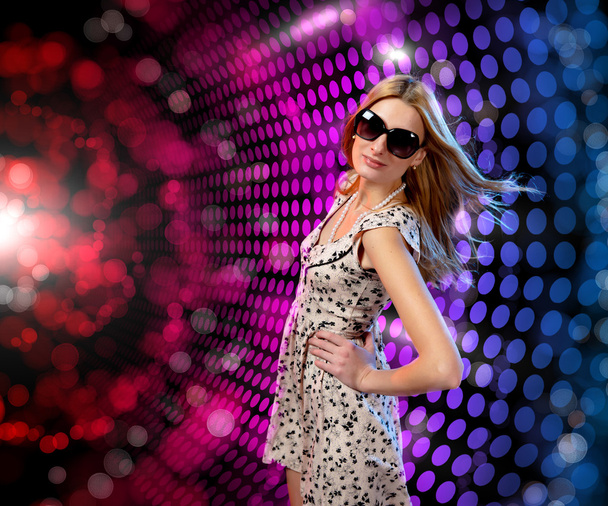 Young woman dancing at disco - 写真・画像