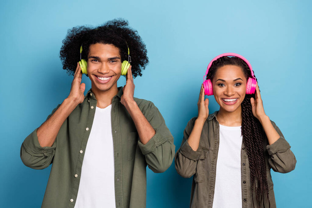 Photo of cool youth fellows guy girl listen radio modern headset wear stylish trendy shirt isolated blue color background - Φωτογραφία, εικόνα