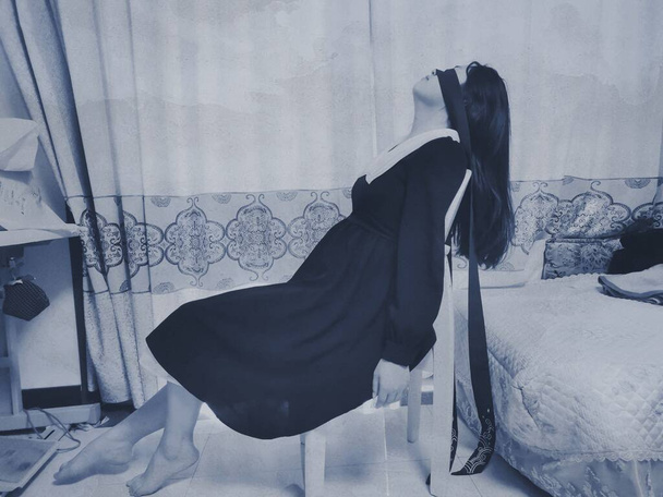 young woman in a black dress with a veil - Fotó, kép