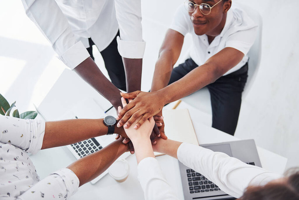 Top view of hands doing success gesture. Group of african american business people working in office together. - Foto, Imagem