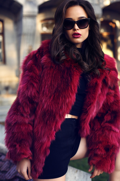 sexy woman with dark hair in luxurious fur coat and sunglasses - Фото, изображение