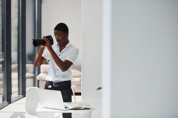 Testing camera. Young african american man in formal clothes is in the office. - Fotografie, Obrázek