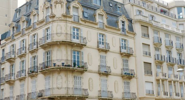 Rounded corner of the old-fashioned building with balconies and windows downtown Biarritz, France. Background, backdrop. - Photo, Image