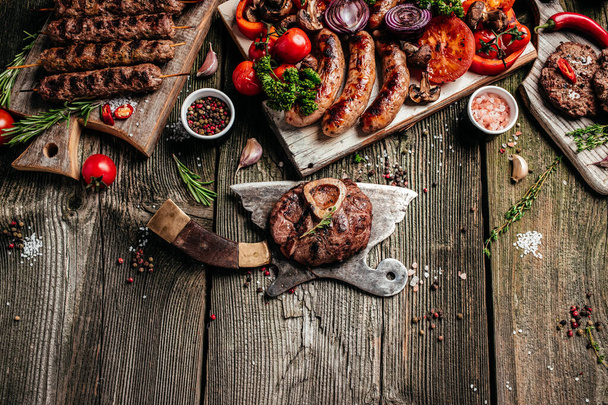 minced meat cutlet burgers on a BBQ grill.. steel grilled meat burger. mix kebab meat. Kebab adana, chicken, lamb and beef. banner, menu, recipe place for text, top view. - Φωτογραφία, εικόνα