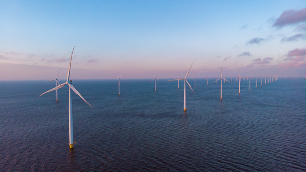 Huge windmill turbines, Offshore Windmill farm in the ocean Westermeerwind park , windmills isolated at sea on a beautiful bright day Netherlands Flevoland Noordoostpolder - Zdjęcie, obraz