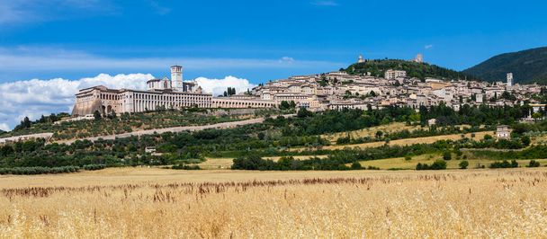 Wioska Assisi w obwodzie Umbria, Włochy. Miasto słynie z najważniejszej włoskiej bazyliki św. Franciszka (Basilica di San Francesco) - Zdjęcie, obraz