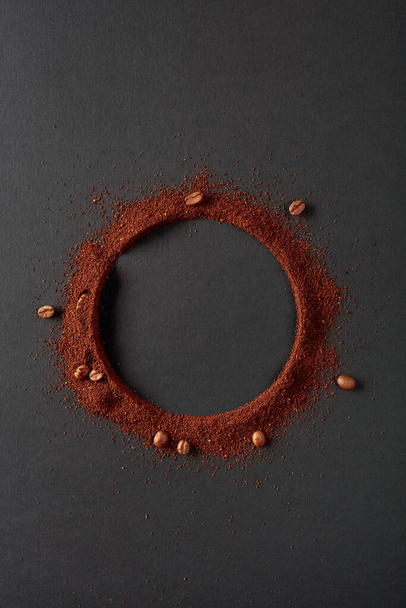 Coffee beans and coffee powder with round copy space. Top view. - Photo, Image