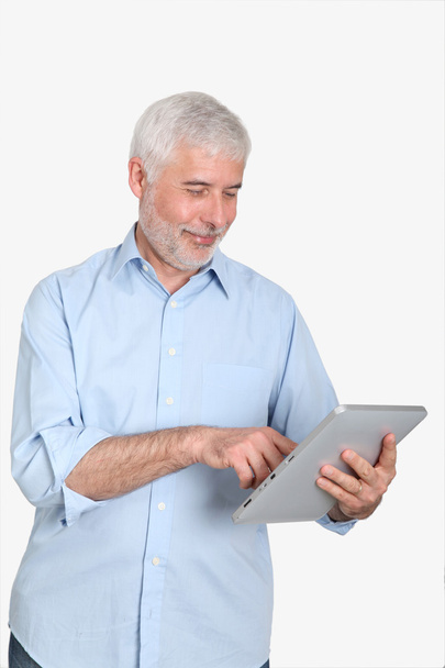 Senior man using electronic tablet - Foto, imagen