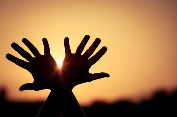Σκιαγραφία από γυναικεία χέρια κατά τη διάρκεια του ηλιοβασιλέματος - Φωτογραφία, εικόνα