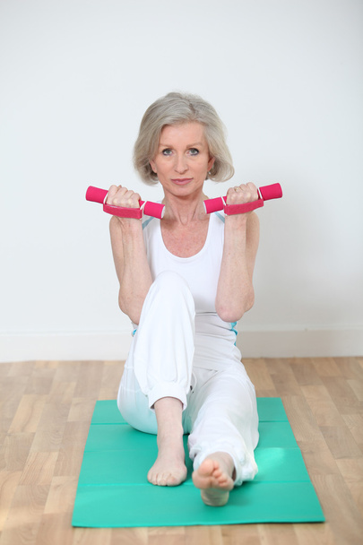 Senior woman doing yoga exercises - Foto, imagen
