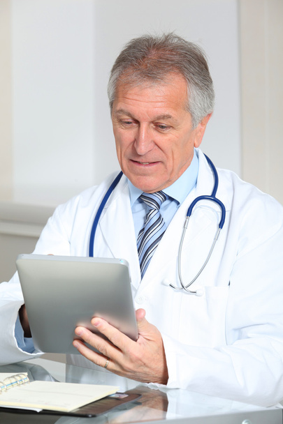 Closeup of doctor in the office with electronic pad - Photo, Image