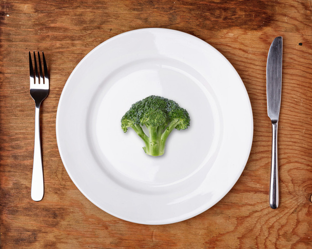 Knife, Fork and plate with broccoli on wooden table. - Zdjęcie, obraz