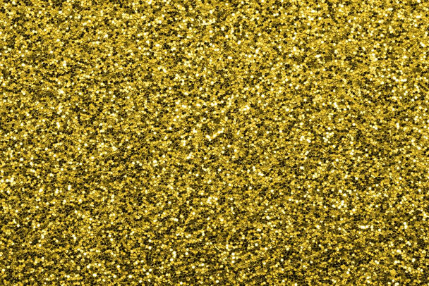 shimmering glitter background with lots of bright yellow golden hues that can symbolize luxury wealth opulence - Photo, Image