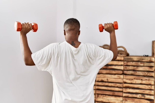Mladý africký muž školení s činky v tělocvičně - Fotografie, Obrázek