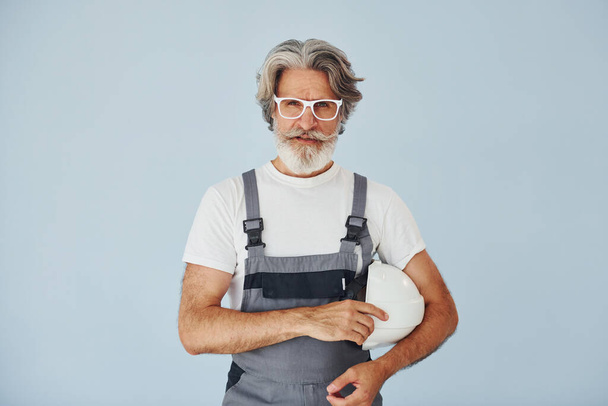 Repairman ready for work. Senior stylish modern man with grey hair and beard indoors. - Foto, immagini