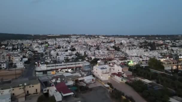 The light of the store at night and the movement of cars. Overnight in Ayia Napa, Cyprus. The camera flies over the city. - Footage, Video