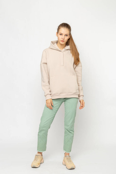 Girl in green cargo pants and beige hoodie isolated on white - Photo, Image