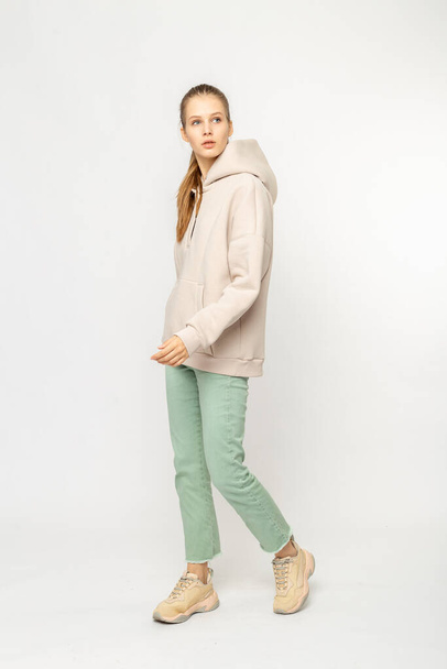 Girl in green cargo pants and beige hoodie isolated on white - Fotografie, Obrázek