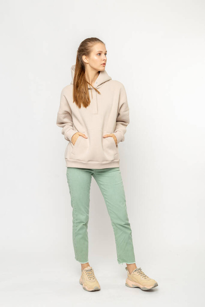 Girl in green cargo pants and beige hoodie isolated on white - Foto, Imagem