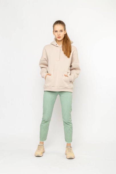 Girl in green cargo pants and beige hoodie isolated on white - Fotoğraf, Görsel