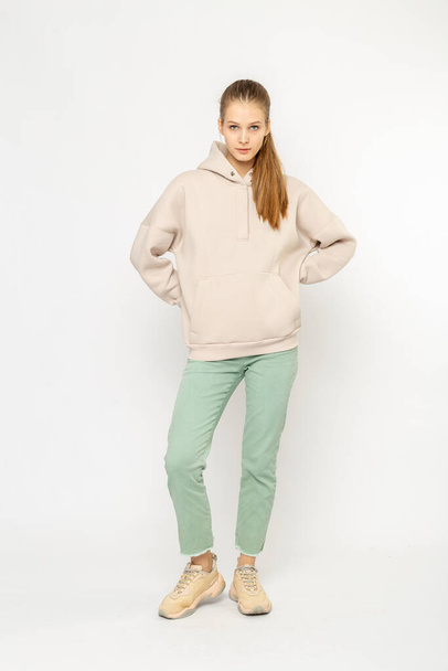 Girl in green cargo pants and beige hoodie isolated on white - Foto, afbeelding