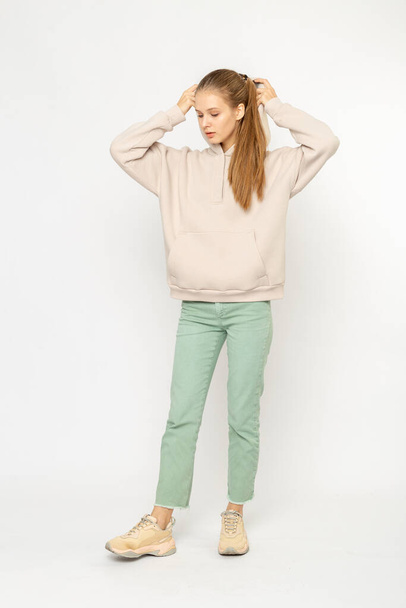 Girl in green cargo pants and beige hoodie isolated on white - Foto, Bild