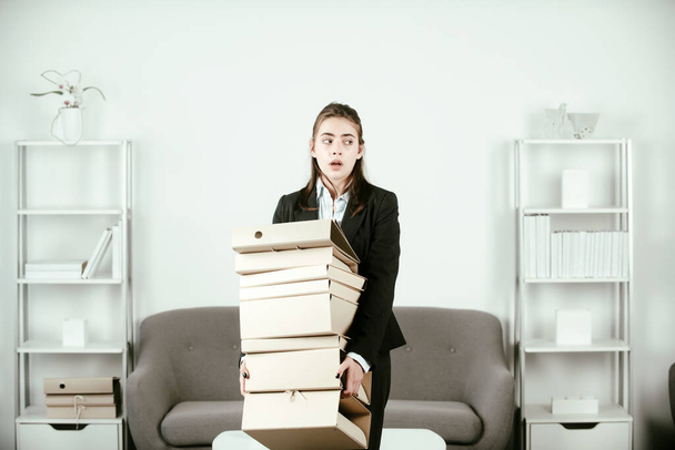 Sadness depressed businesswoman holding many folders with the documents, frustration secretary girl, stressed employee working overtime with too much work, office problem at workspace. - Foto, Bild