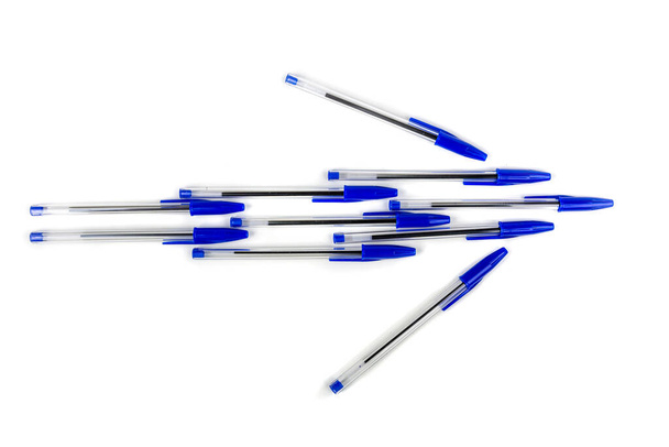 Blue writing pens, arrow or plane shaped office supplies new with caps isolated over white - Foto, Imagen