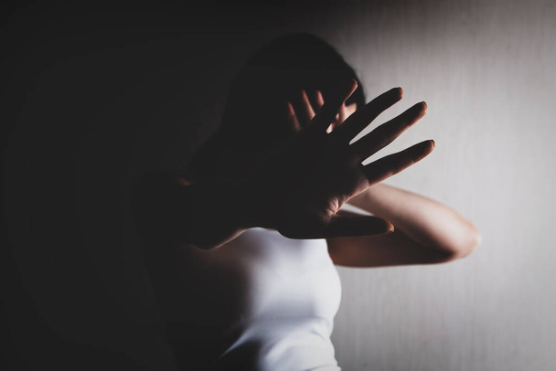 Closeup image of a woman outstretched hand and showing stop hand sign - Photo, image