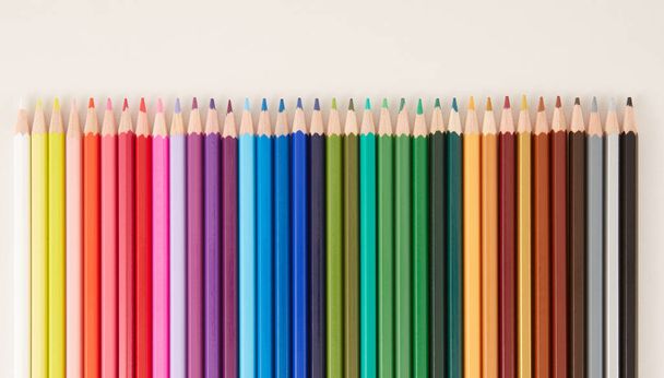 Interlocking colored pencils top view - Фото, изображение