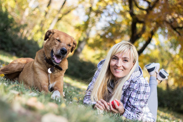 Positive young woman enjoying happy moments with her dog - Photo, Image