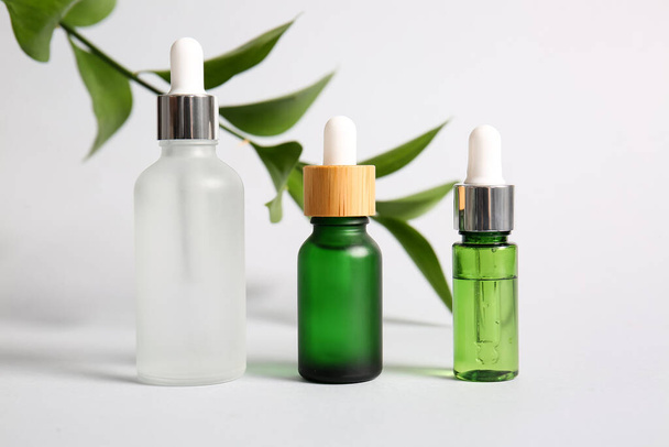 Bottles of natural serum on white background - Photo, Image