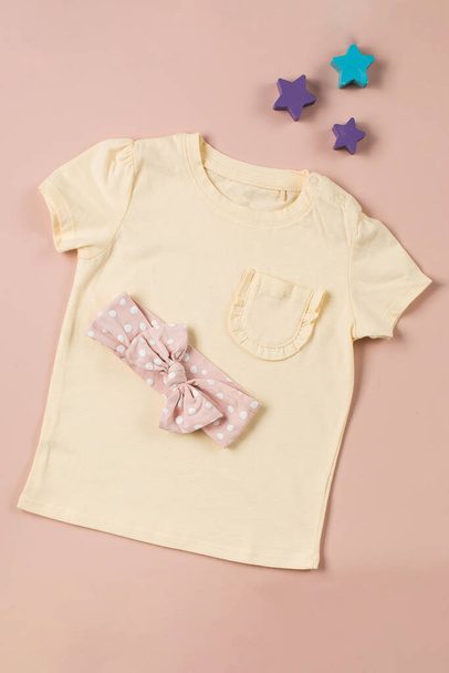 Yellow childrens T-shirt and headband with a bow. Beautiful look for a girl.  - Photo, image