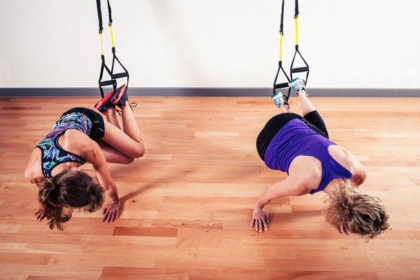 Two women working out with straps - Fotoğraf, Görsel