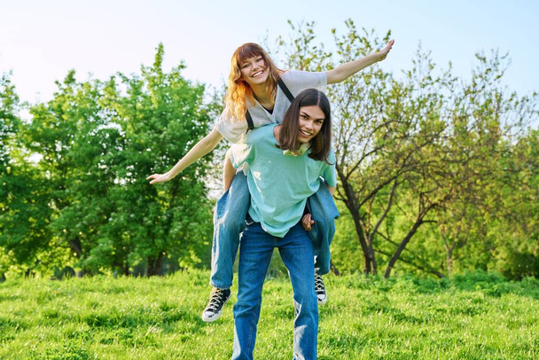 Couple of happy having fun teenagers together outdoor - Photo, Image