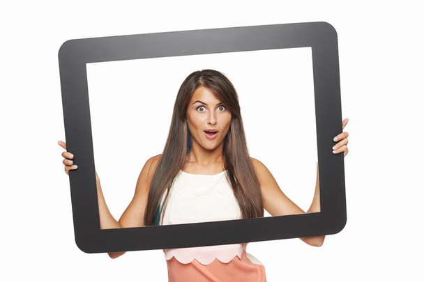 Excited woman looking through tablet frame - Fotoğraf, Görsel