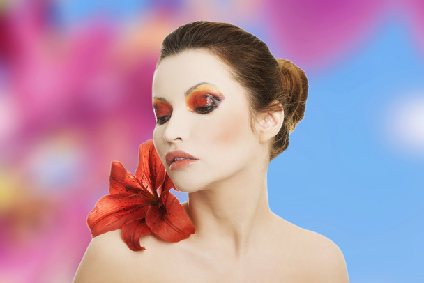 Young woman with red lilly - Zdjęcie, obraz