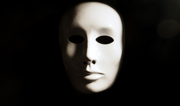 White face mask on dark background. - Foto, Imagem