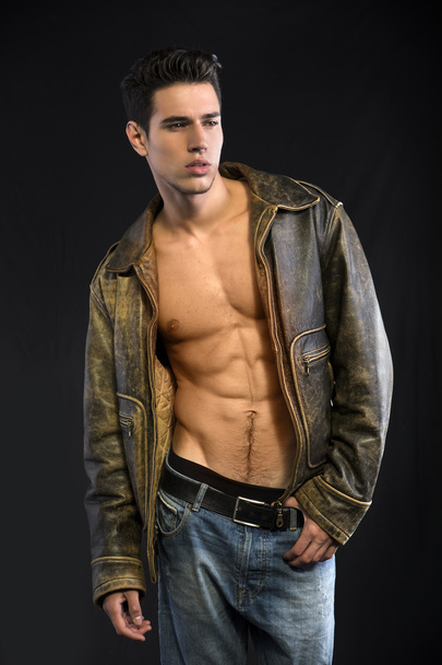 Handsome young man wearing leather jacket on naked torso - Fotoğraf, Görsel