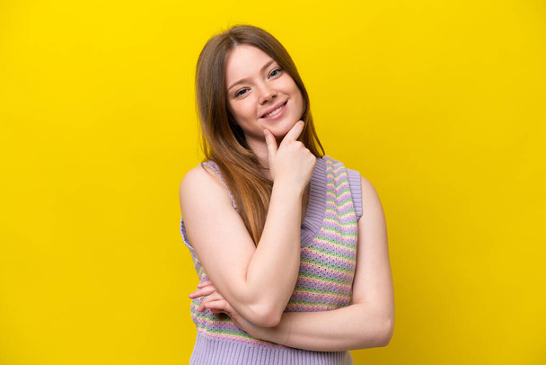 Young caucasian woman isolated on yellow background happy and smiling - Photo, Image