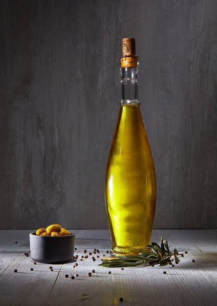 Extra virgin olive oil product over wooden table - Foto, immagini