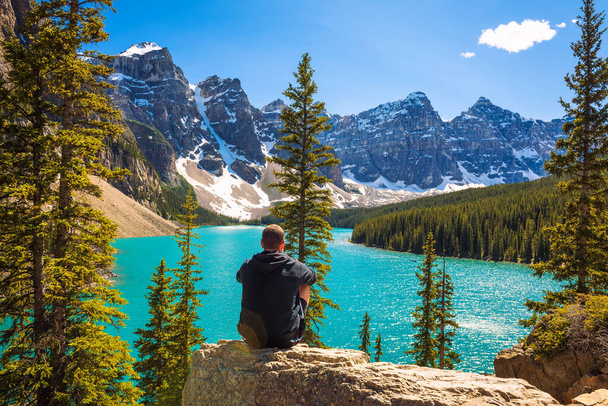 Hiker enjoying the view of Moraine lake in Banff National Park - Photo, Image