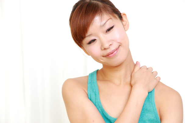 Young woman doing self shoulder massage - Foto, immagini