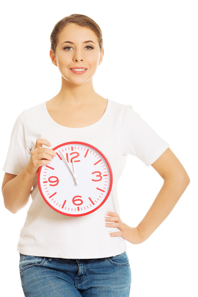 Woman holding a clock - Фото, зображення