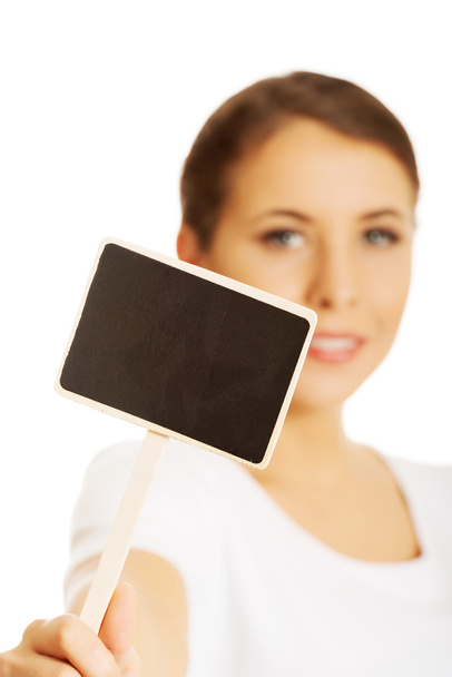 Woman holding a small panel - Foto, Imagen