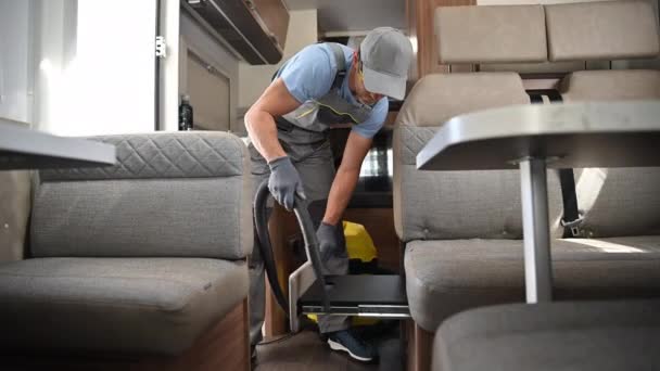 Industrial RV Rental Worker Vacuuming a Camper Van. Preparing Motorhome For a Next Client. Recreational Vehicles Maintenance Theme.  - Footage, Video