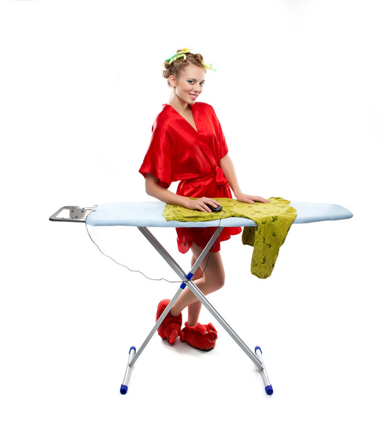 Woman ironing clothes with a computer mouse - 写真・画像