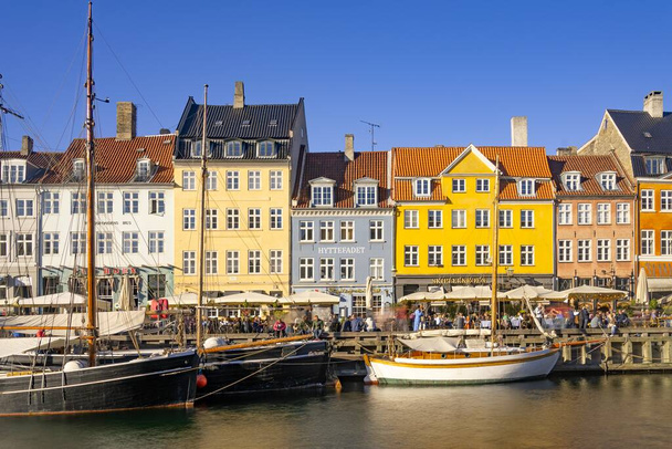 Nyhavn district is one of the most famous Danish landmark in Copenhagen in a summer day. Picture taken in the capital of Denmark  - Photo, Image