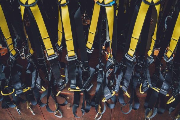 Rows of climbing safety ropes and carabiners and helmets - Foto, Imagem