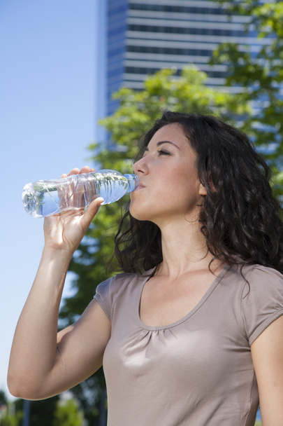 міська жінка п'є воду
 - Фото, зображення